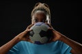 Female Football Player Holding Ball with Intense Face Royalty Free Stock Photo