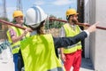 Female foreman coordinating and guiding workers on the construction site