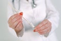 Female forensic technician collecting biological specimen in DNA