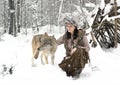 Female forest dweller with a wild wolf in the winter forest