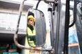 Woman forklift truck driver in an industrial area. Royalty Free Stock Photo