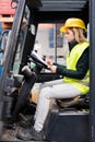 Female forklift truck driver outside a warehouse. Royalty Free Stock Photo