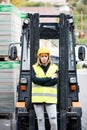 Female forklift truck driver outside a warehouse. Royalty Free Stock Photo