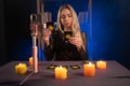 Female fortune teller reads tarot cards for predictions, telling customers by providing services via webcam of mobile Royalty Free Stock Photo