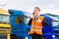 Female forwarder in front of trucks on a depot Royalty Free Stock Photo