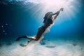 Female freediver underwater. Freediving in transparent sea