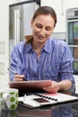 Female Freelance Worker Using Digital Graphics Tablet At Home Royalty Free Stock Photo