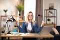 Female freelancer in eyeglasses meditating at table, feeling relaxed Royalty Free Stock Photo