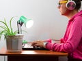 Female freelancer in headphones laptop Work from home, distance e-learning office. Pretty student girl drinking coffee Royalty Free Stock Photo