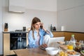Female freelancer making business call while working remotely from home Royalty Free Stock Photo