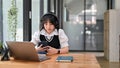 A female freelancer or student is listening to music through her headphones Royalty Free Stock Photo