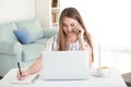 Female freelancer talking by phone while working in home office Royalty Free Stock Photo