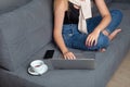 Female freelancer working home. Girl using laptop preparing her project and making notes in copybook. Royalty Free Stock Photo