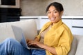 Female freelancer working in relaxed atmosphere, answering emails. Young multiracial beautiful woman using laptop at