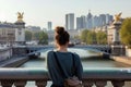 female with a french twist admiring city views from a bridge