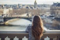 female with a french twist admiring city views from a bridge