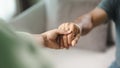 Female friend or family sitting and hold hands during cheer up to mental depress man, Psychologist provides mental aid to patient Royalty Free Stock Photo