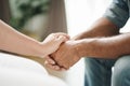 Female friend or family sitting and hold hands during cheer up to mental depress man, Psychologist provides mental aid to patient Royalty Free Stock Photo