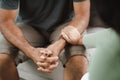 Female friend or family sitting and hold hands during cheer up to mental depress man, Psychologist provides mental aid to patient Royalty Free Stock Photo