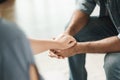 Female friend or family sitting and hold hands during cheer up to mental depress man, Psychologist provides mental aid to patient Royalty Free Stock Photo