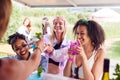 Female Friends Buying Drinks From Bar At Music Festival Royalty Free Stock Photo