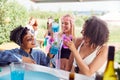 Female Friends Buying Drinks From Bar At Music Festival Making A Toast Royalty Free Stock Photo