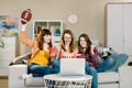Female friends cheering sport league, watching football together at home. The Three emotional women on the sofa watch a