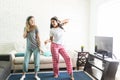 Female Friends Dancing While Listening To Music On Headphones Royalty Free Stock Photo