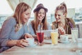 Female friends enjoying in conversation and drinking coffee in cafe Royalty Free Stock Photo