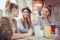 Female friends enjoying in conversation and drinking coffee in cafe Royalty Free Stock Photo