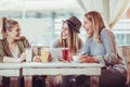 Female friends enjoying in conversation and drinking coffee in cafe Royalty Free Stock Photo