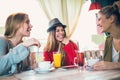 Friends enjoying in conversation and drinking coffee. Royalty Free Stock Photo