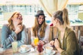 Friends enjoying in conversation and drinking coffee. Royalty Free Stock Photo