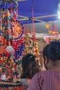 Female friends enjoying a vibrant display of traditional Indian wind chimes