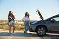 Girls with a broken a car on country road Royalty Free Stock Photo