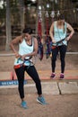 Female friends getting their belt tied to perform zip line Royalty Free Stock Photo