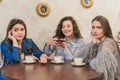 Female friends having a coffee together. Three women at cafe drinking, talking, laughing and enjoying their time Royalty Free Stock Photo