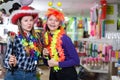 Female friends having fun in festival outfits store Royalty Free Stock Photo