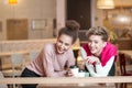 Female friends having lunch at mall cafe laughing and smiling after shopping Royalty Free Stock Photo