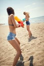 Female friends playing with water-guns on beach Royalty Free Stock Photo