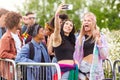 Female Friends Taking Selfie As They Arrive At Entrance To Music Festival Royalty Free Stock Photo