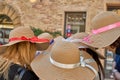 Female friends wearing stylish hats, one with a pink ribbon and one with a bow