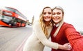 Female friendship concept with girls couple taking selfie outdoors in London - Lgbtq genuine love relationship