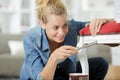 Female furniture designer using chisel on chair frame