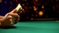 Female gambler holding dollar banknotes, lights sparkling on background, casino