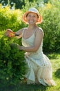 Female gardener cutting thuja