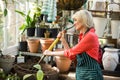 Female gardener digging soil with gardening fork