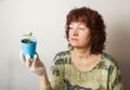 A female gardener shows a pot with sprouts after a pick