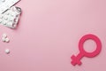 Female gender sign, pills and space for text on background, flat lay. Women`s health concept