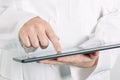 Female general medical practitioner using tablet computer